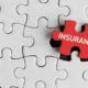 Photo of a puzzle with the final piece being placed labeled insurance.