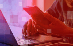 How tech could drive the next wave of democratisation A person is reading their phone while sitting in front of a laptop